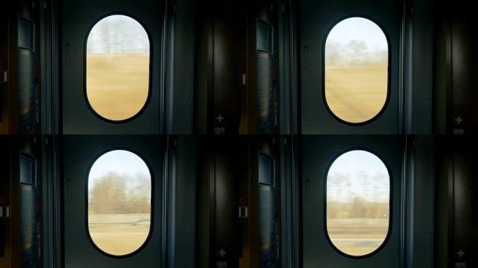 通过移动的火车门窗的户外风景
