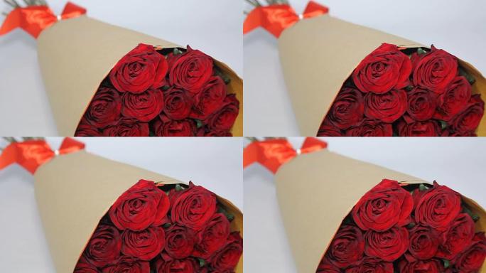 纸质包装的红玫瑰花束。静态