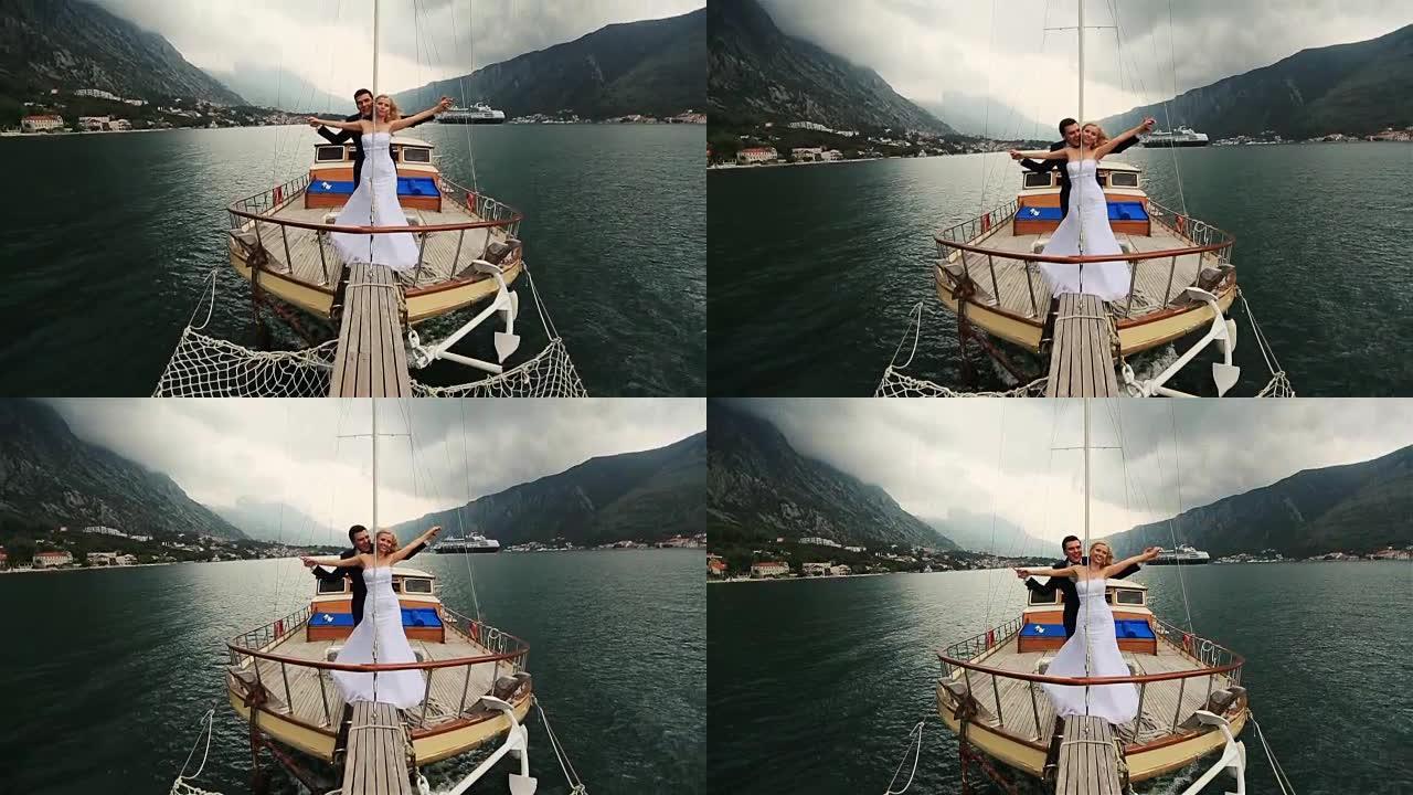 婚礼情侣牵手在布德瓦黑山海上航行的船尾