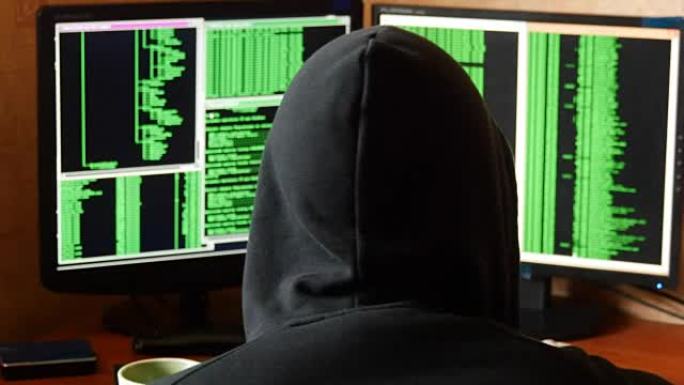 黑客破解密码，从你办公桌前的杯子里喝酒。黑罩的犯罪黑客从他黑暗的黑客房间穿透网络系统。