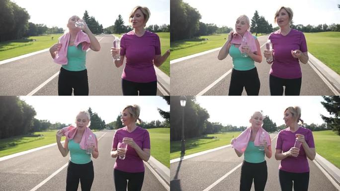 健身老年妇女慢跑后喝水