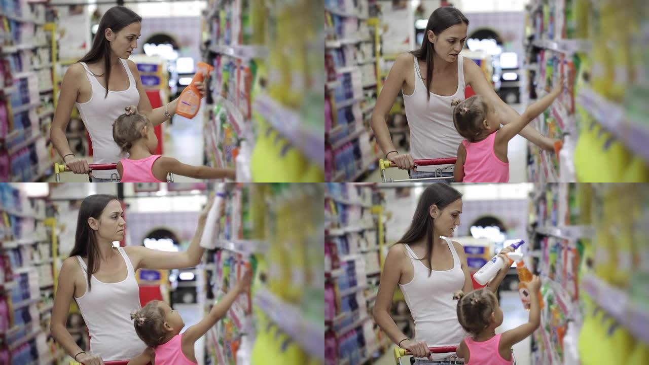 有小女儿的年轻妇女在超市为家里选择洗涤剂