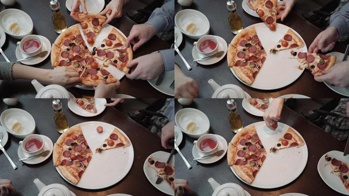 手拿披萨切俯视图，特写镜头。在咖啡馆里，交流和朋友