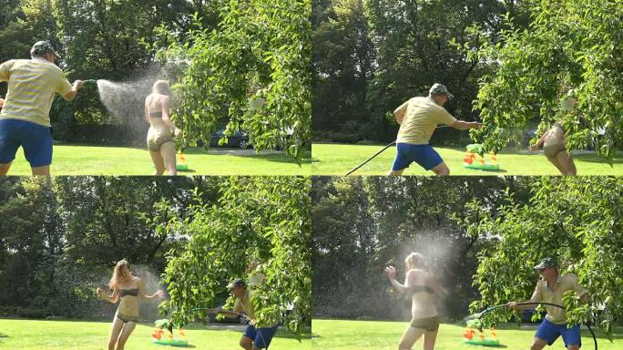 男人在花园院子里用水管抓住和喷洒内衣的女人女孩