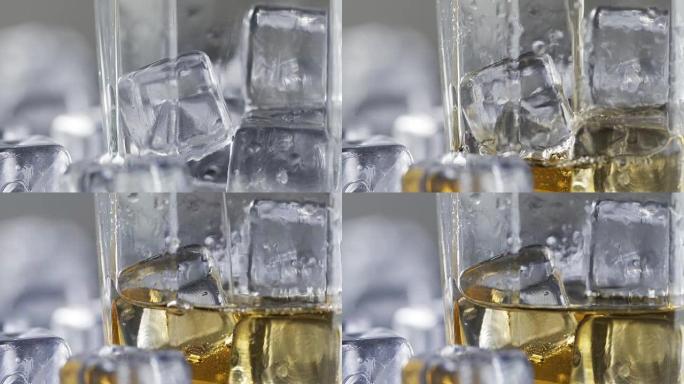 关闭将威士忌倒在冰块上的玻璃杯中。
