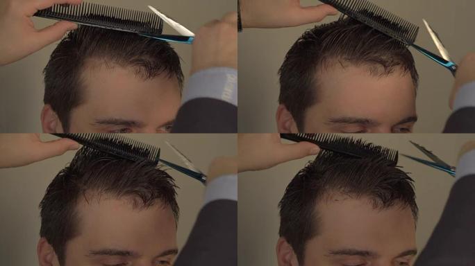发型师的手用梳子修剪头发