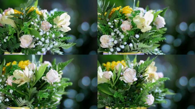 特写镜头，花束在光线中，旋转，花卉组成由非洲菊，玫瑰介子形，绿藻，一枝黄花，满天星，蛛形纲组成