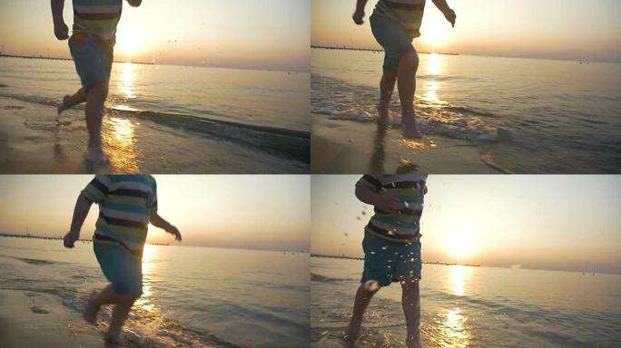 赤脚小孩在日落时在海水中奔跑