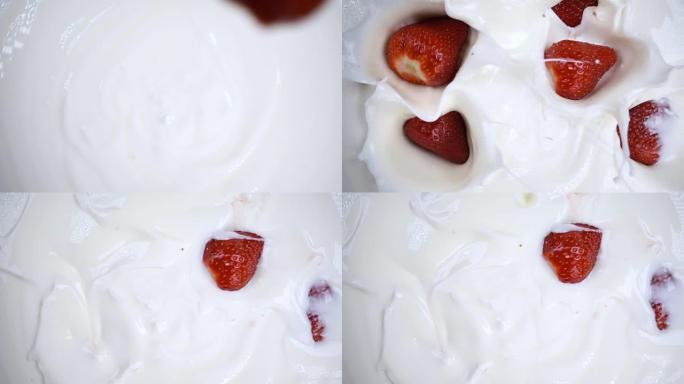 草莓落入白色酸奶奶油中