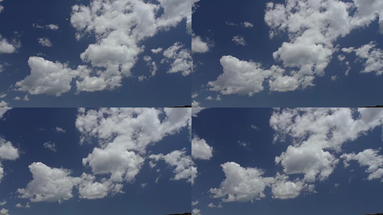 在蔚蓝的夏日天空下，云在完美的流体运动中的时间流逝