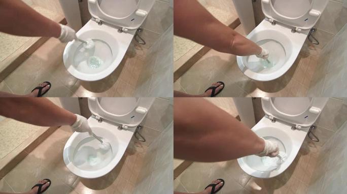 女人戴着手套在家里或酒店房间的浴室清洁马桶