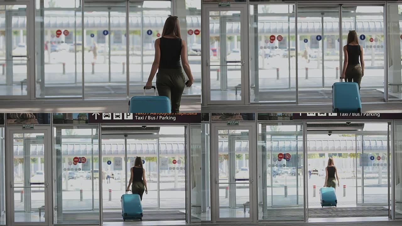 年轻美丽的女人正在步行机场大厅