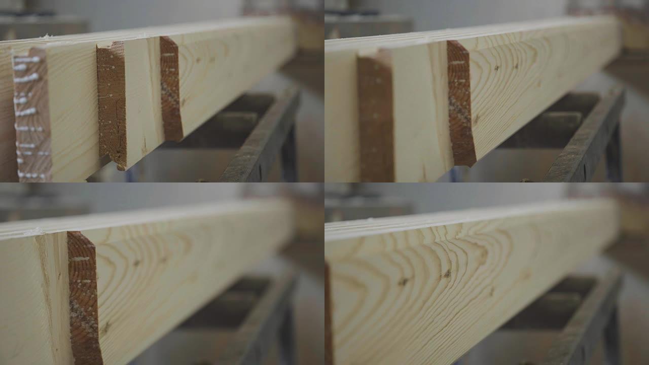 板条从机器下面出来。木制锯末