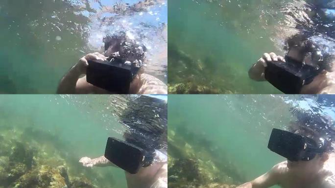 中视角男子戴着虚拟现实耳机，在热带浅海水下游泳