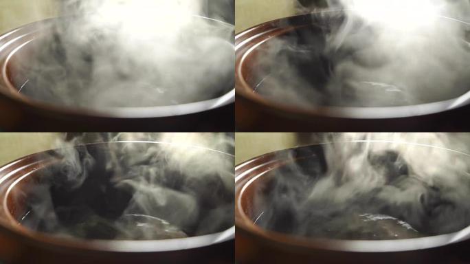 棕色锅中蒸水，慢动作视频