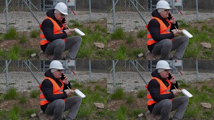 工人坐在智能手机上聊天