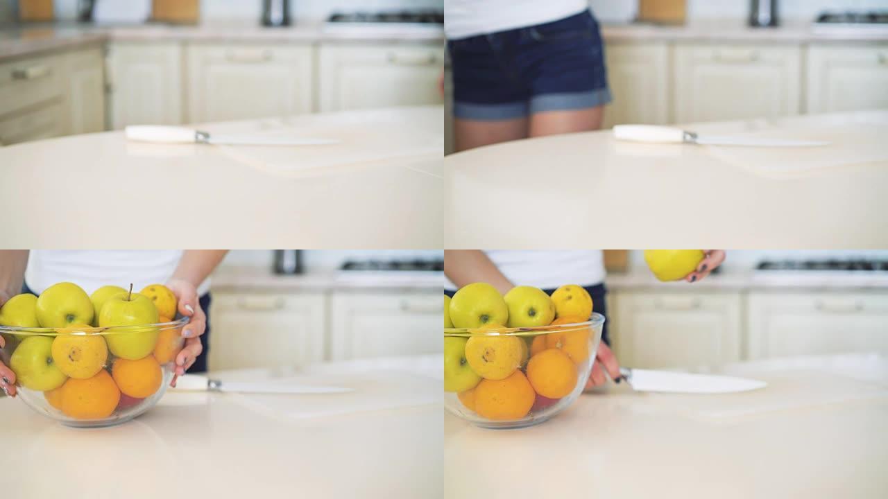 女孩把碗里有水果，把苹果切成全高清
