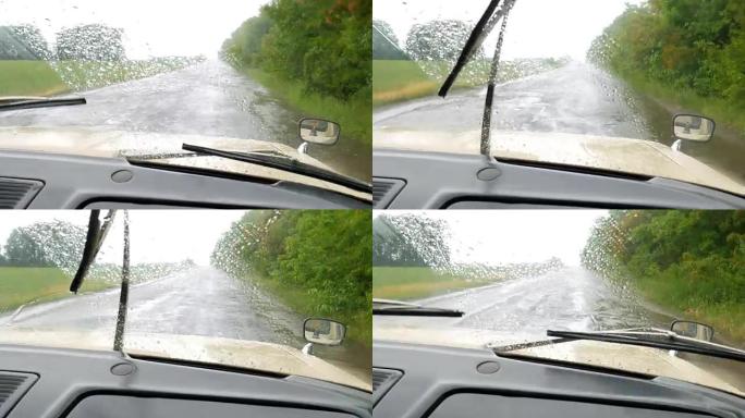 在大雨中行驶在潮湿的高速公路上的汽车坠落。能见度差。