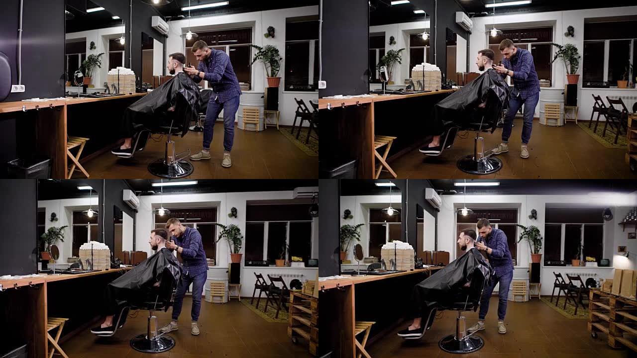 理发师将切割机应用于坐在理发店椅子上的客户