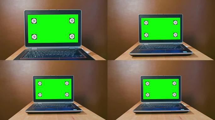 将相机平移到带有绿色屏幕的笔记本电脑上
