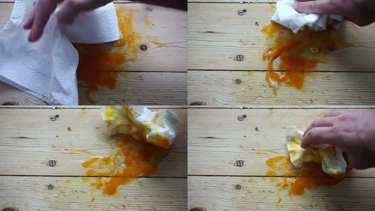 地板上的新鲜鸡蛋碎了，用手擦掉了