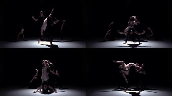 五位舞者在黑色，阴影，慢动作上的优美当代舞蹈