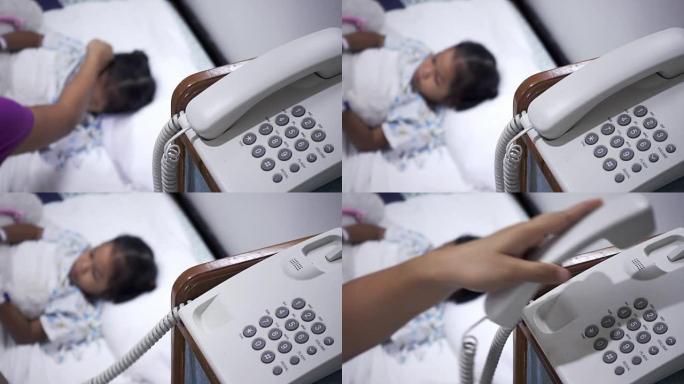 女性使用旧电话的特写镜头，生病的小孩在卧室里模糊。