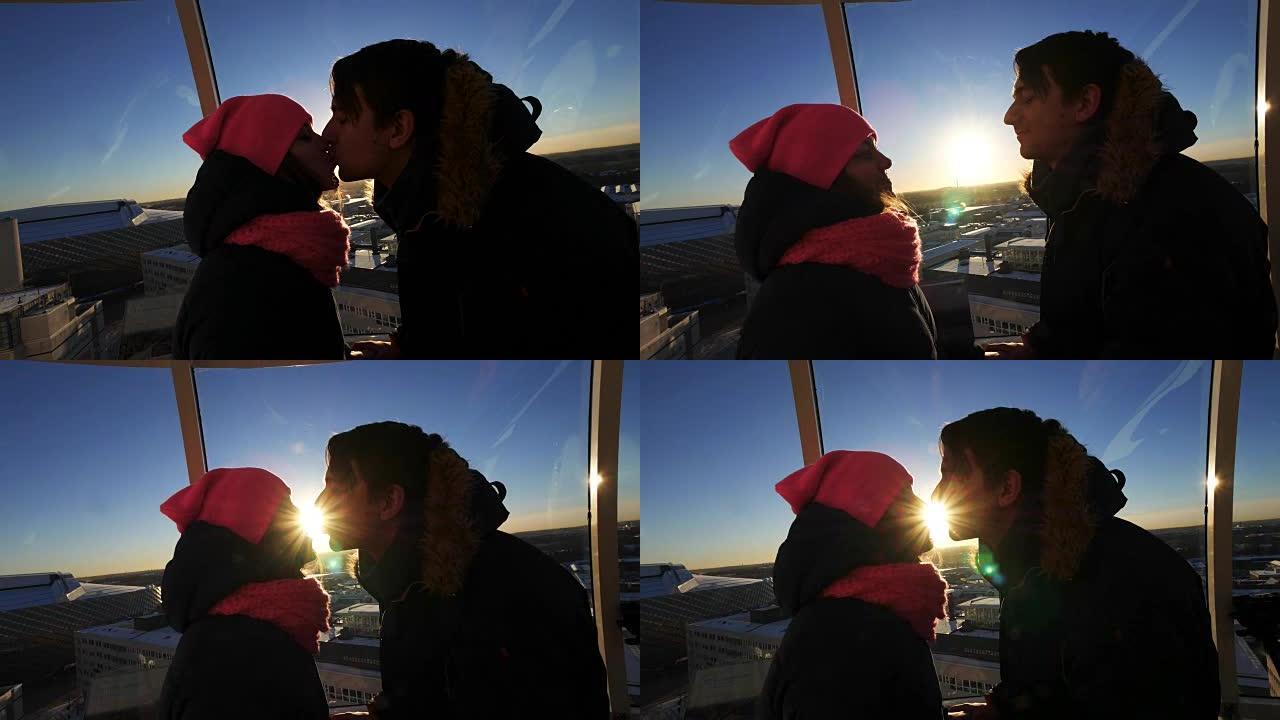 夫妇在瑞典国家室内竞技场爱立信环球报的胶囊内的阳光下接吻