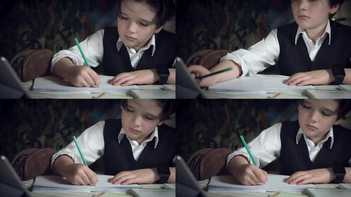 4k高科技拍摄一个孩子做作业并检查他的平板电脑