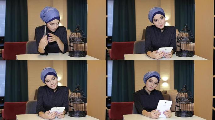 年轻的穆斯林女孩使用平板电脑