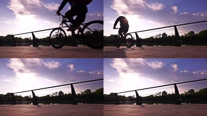 阳光路堤上无法识别的骑自行车者的慢动作视频