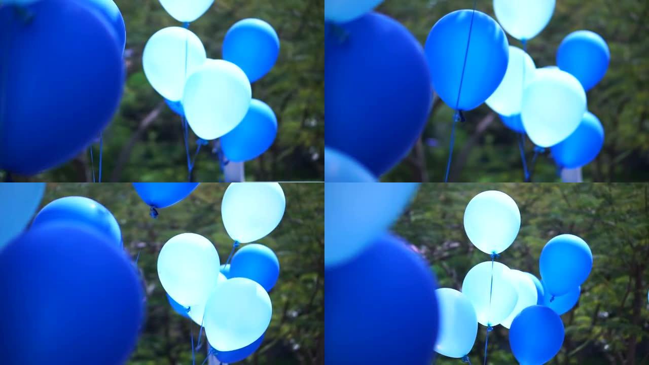蓝色派对气球漂浮在户外露台上，庆祝活动充满乐趣和明亮的一天