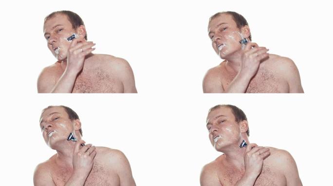 成年男子用泡沫剃须和手动刮胡刀剃须。慢动作