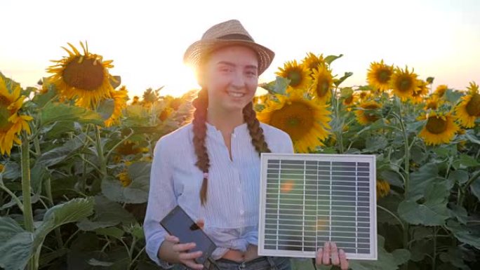环保，背光中的女性微笑保持在手中移动和太阳能电池跟踪太阳给电池充电