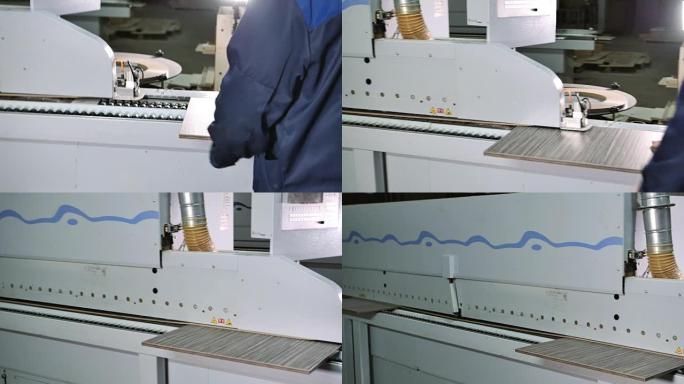 工人将胶合板放在封边机上