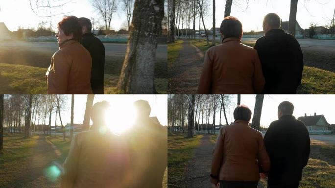 日落时分，爱在公园散步的老年夫妇。附近有一条路。一个穿着棕色皮夹克的女人。这个男人穿着一件黑色毛衣