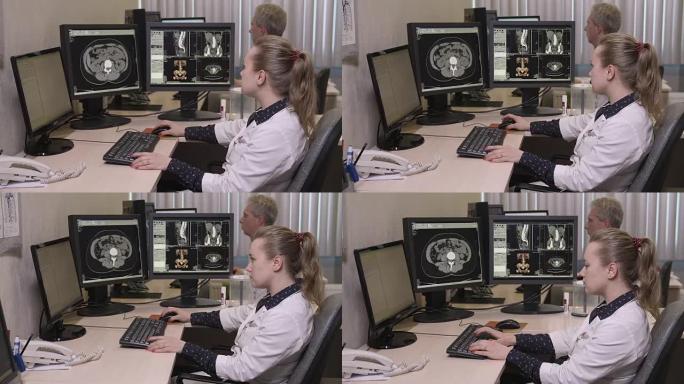 年轻医生在电脑上打字的侧视图