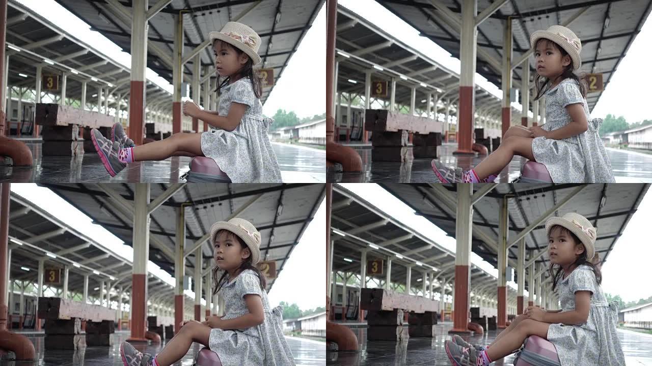 火车站站台上的亚洲旅游小女孩候车。慢动作。