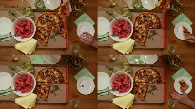 三个人餐桌上的大披萨，男人吃一块温暖的零食