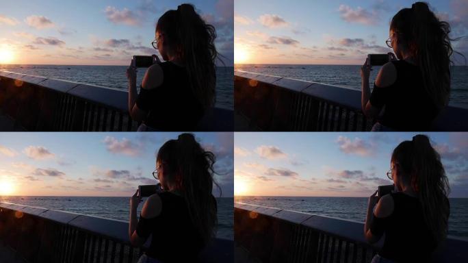 年轻女孩在特拉维夫的地中海贾法拍摄美丽的日落照片。