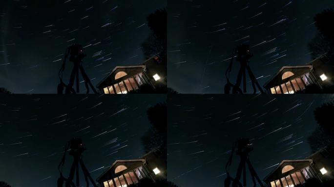 星空足迹在天空中移动，三脚架上的相机在前景中