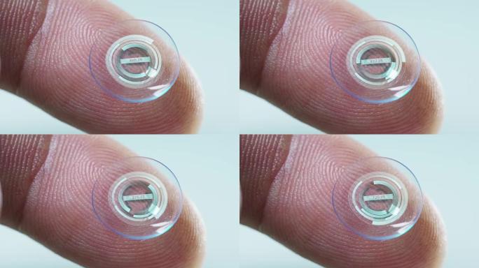 手持隐形眼镜技术的手指的微距拍摄，带有芯片，可以在两只眼睛中更好地看到并增加屈光度。概念: 眼科检查