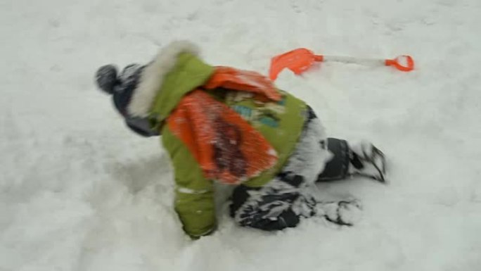 在新鲜的深雪中爬行的孩子