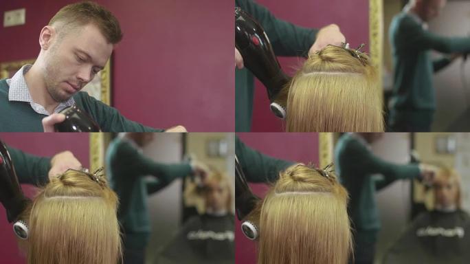 理发师风格的女孩头发在美容沙龙用梳子和吹风机。制作体积发型。镜子