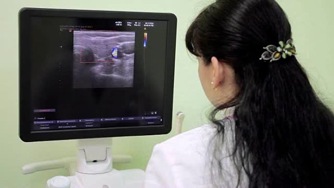医院的计算机监视器屏幕上的女性放射科医生分析医学影像。放射科病房。放射科医生分析病人。医生做体检