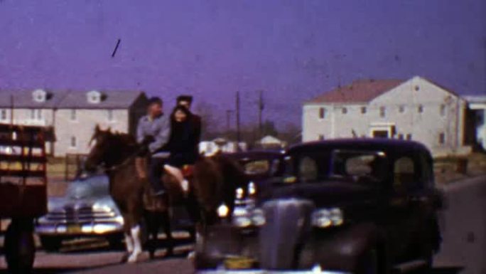 1955: 家庭过街骑马作为老爷车驶过。