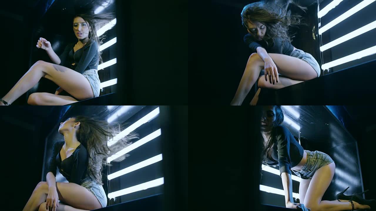 性感的黑发女孩跳舞，躺在立方体上。在慢动作的红色史诗巨龙电影相机上拍摄。