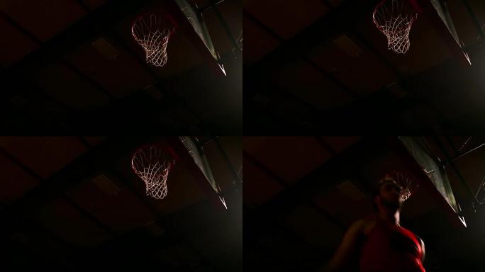 篮球运动员扣篮，黑暗照明，慢动作，从下面看