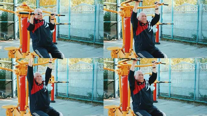 老人在公共户外健身房用健身器材锻炼。
