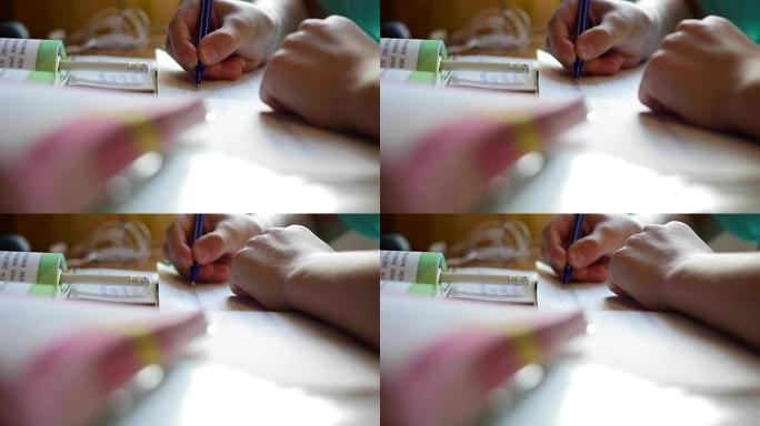 孩子做作业，在桌子特写的抄写书中写
